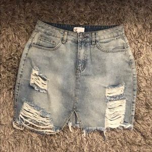 Distressed light blue denim skirt
